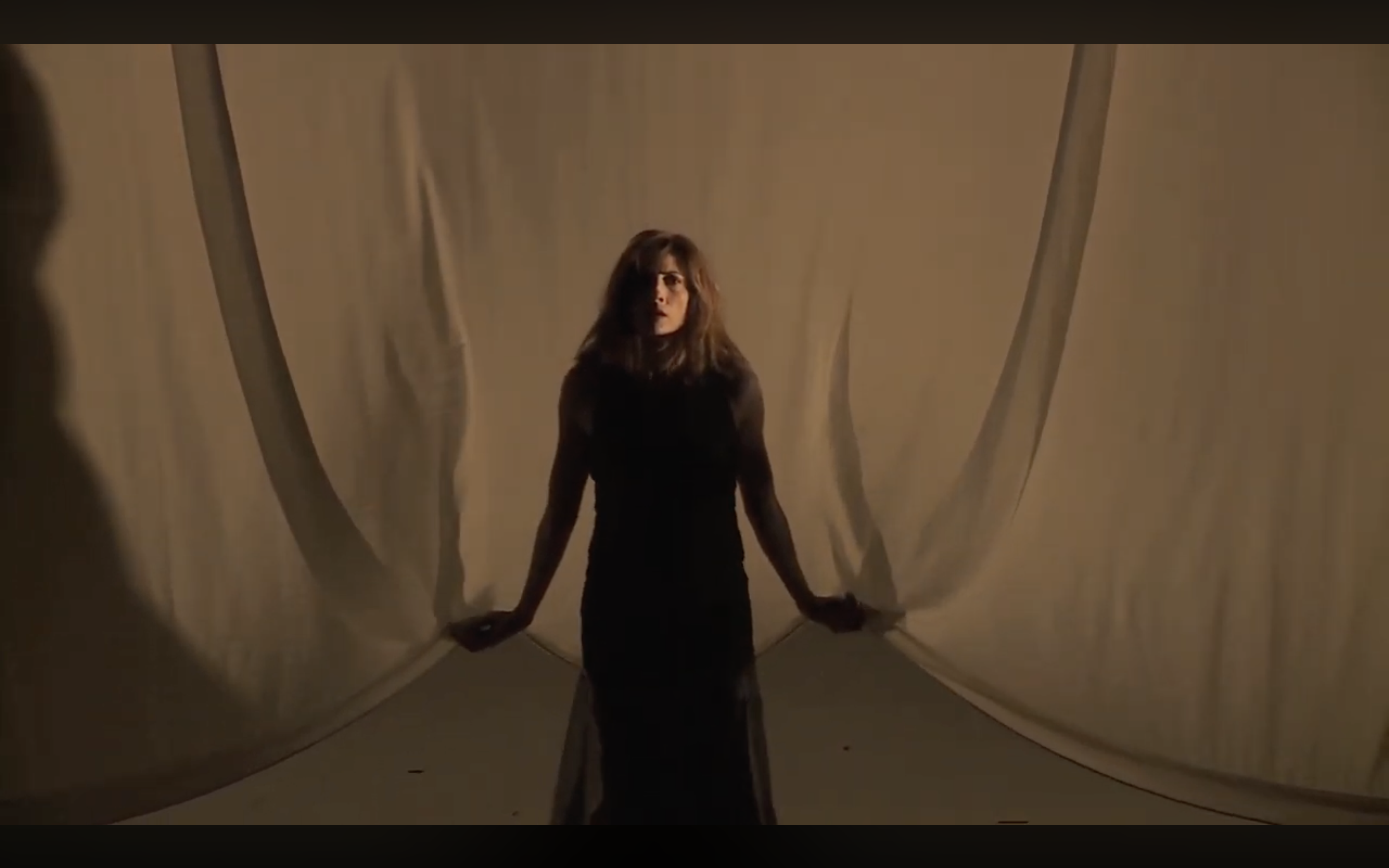 The Step-Daughter emerging through the curtain threshold