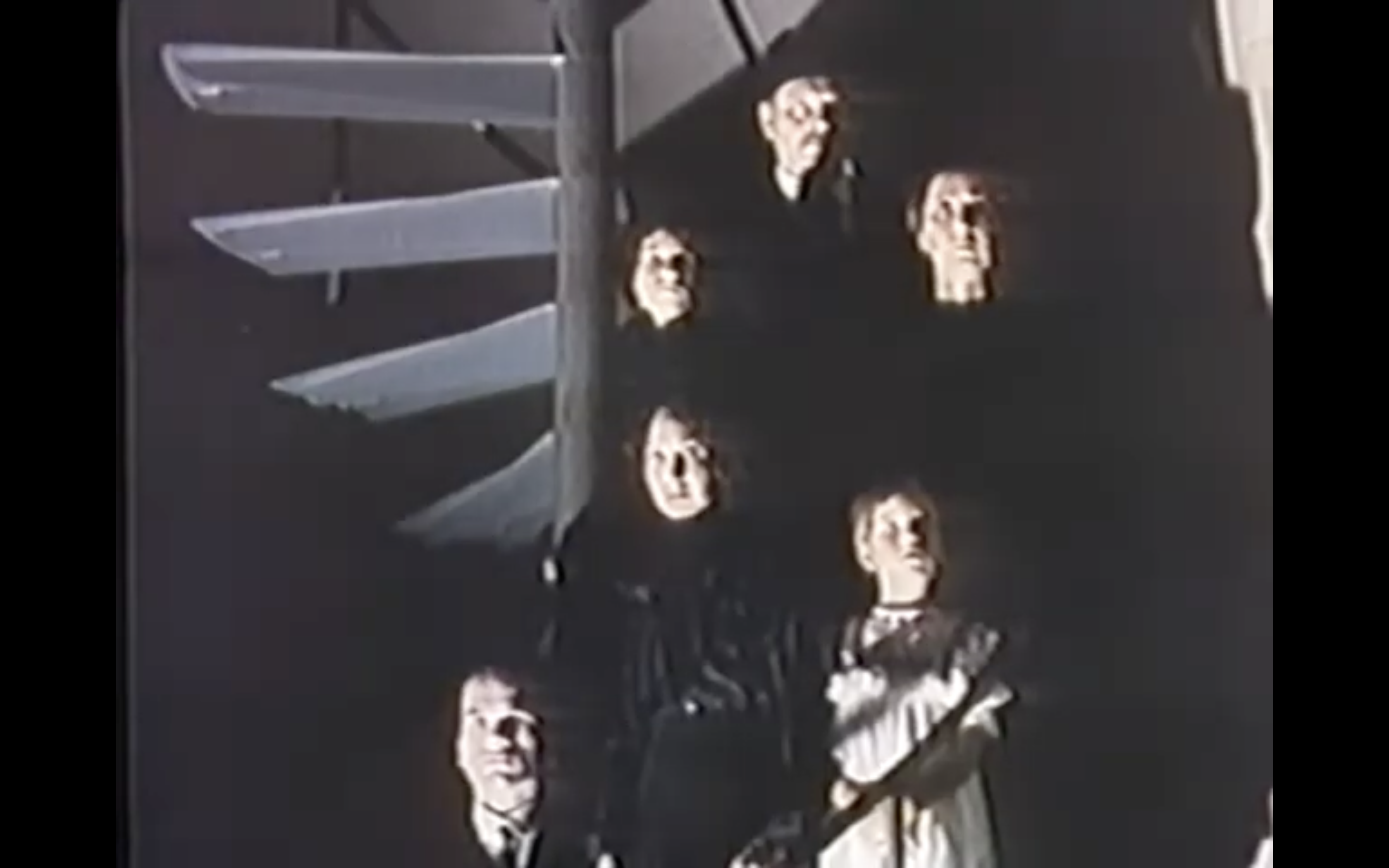 Kenneth Frankel's production (1976): Characters on stairs with harsh lighting